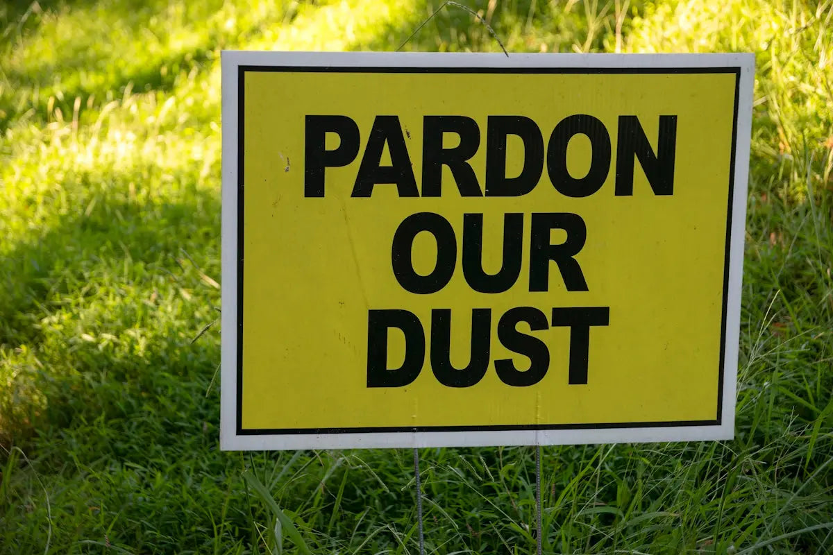 a yellow sign in the grass